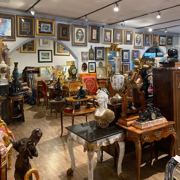 Antique showroom display with artwork and furniture