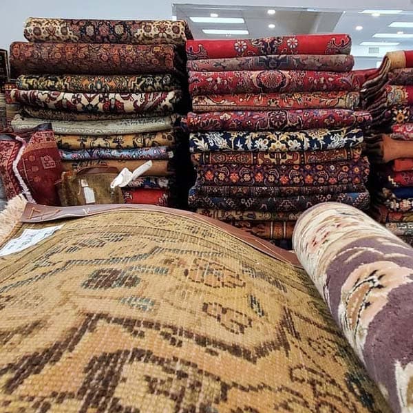 Collection of stacked antique rugs